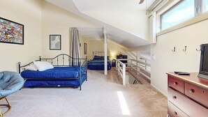 A bedroom with a bed, a chair, a dresser, and a television. - Comfort, convenience & amenities: close to skiing, hiking & shopping (Bartlett)