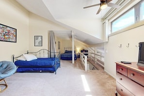 A bedroom with a bed, a chair, a dresser, and a television. - Comfort, convenience & amenities: close to skiing, hiking & shopping (Bartlett)
