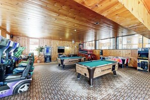 A wooden interior with pool tables and arcade machines. - Comfort, convenience & amenities: close to skiing, hiking & shopping (Bartlett)