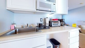 A kitchen with a microwave, toaster, coffee maker, and a sink. - 2nd-floor studio 1 block from the beach with pool, beach access, grills, & W/D (Hampton)