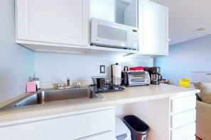 A kitchen with a microwave, toaster, coffee maker, and a sink. - 2nd-floor studio 1 block from the beach with pool, beach access, grills, & W/D (Hampton)
