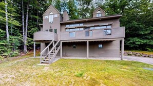 A multi-level wooden cabin with a staircase, large windows, and a deck. - Mountain view retreat with fast WiFi, washer/dryer, & central AC (Jackson)