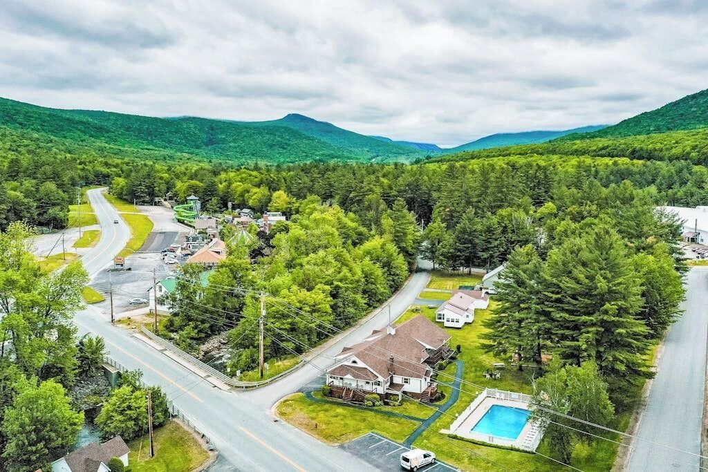 A residential area with houses, a swimming pool, and a road.