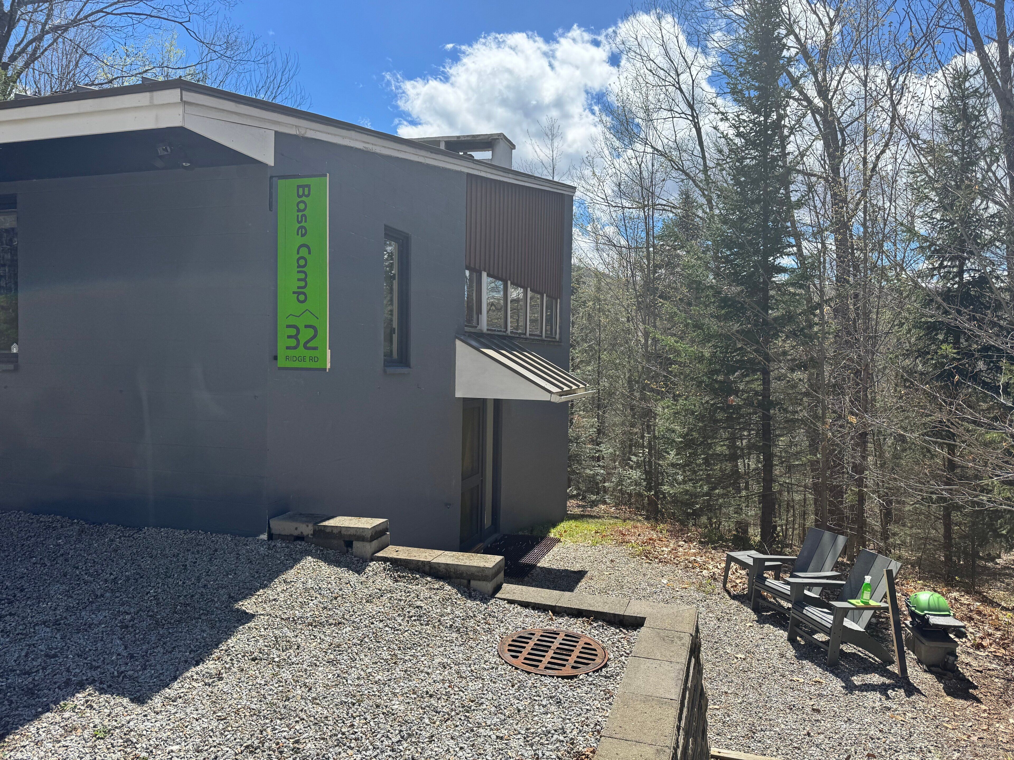 A modern building with a sign reading 'Base Camp 32 Ridge Rd.'