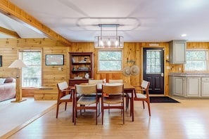 A wooden interior with a dining area, kitchen, and a door marked 'Pine Tree Inn.' - Stunning lakefront home with private dock, deck, firepit, and lake view (Wakefield)