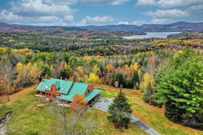 A house with a green roof surrounded by autumn foliage. - Stunning home with Moore Reservoir views and private sunroom (Littleton)