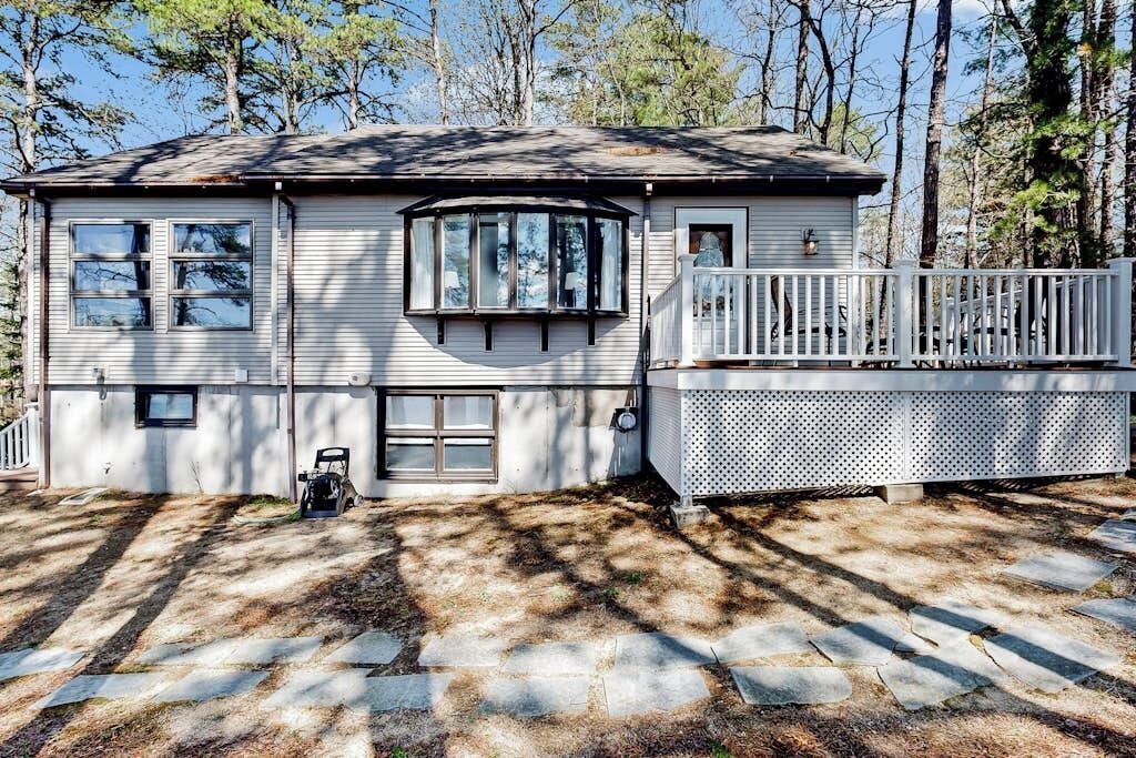A single-story house with a porch, a garage, and a stone pathway.