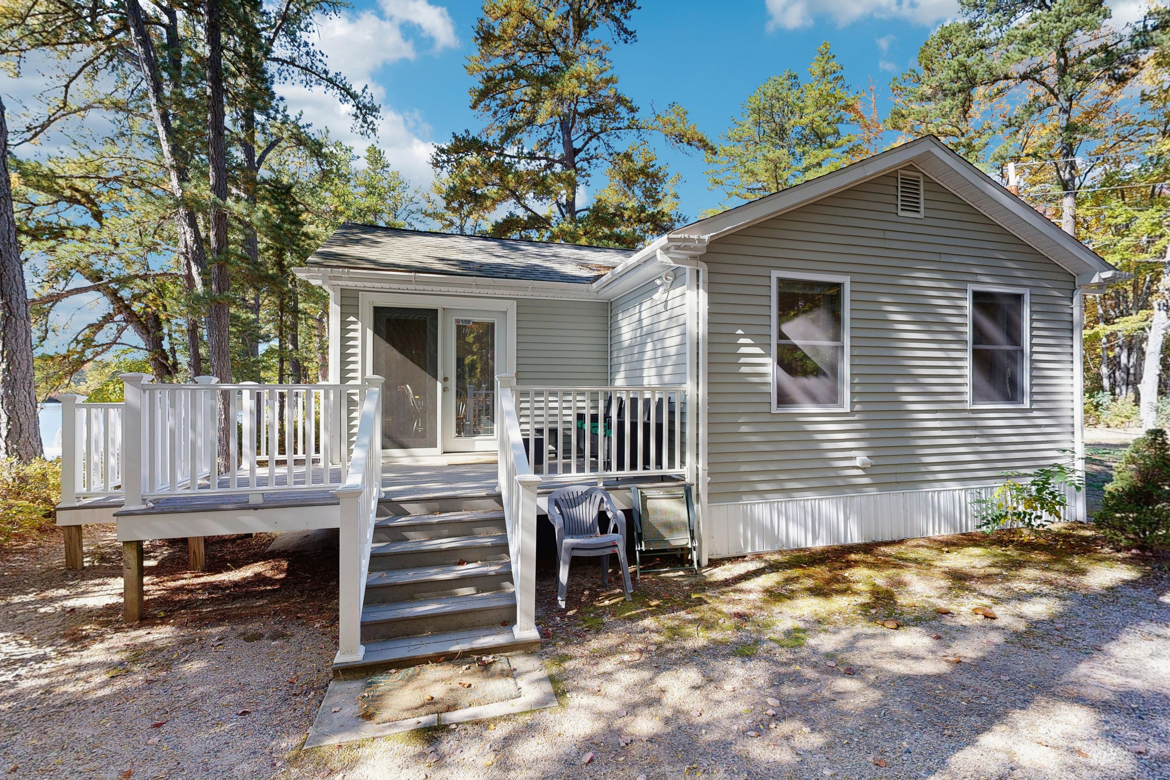 A small cabin with a porch and steps leading to the entrance.
