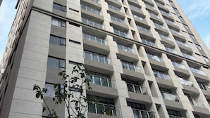 A high-rise building with multiple balconies and large windows. - 2-bedroom apartment on 18th floor in adorable Nairobi with fitness room access, (Nairobi)