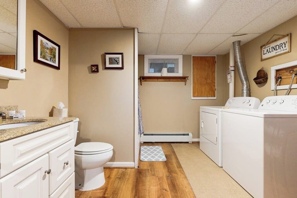 Un baño con inodoro, lavamanos y zona de ducha.