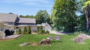 A residential property with a well-maintained lawn, a barbecue area, and a garage. - Intown home w/ views, private deck & firepit; close to  Mt. Cranmore (North Conway)