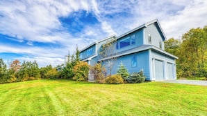 A two-story house with a well-maintained lawn and a garage.