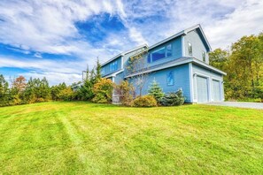 A two-story house with a well-maintained lawn and a garage. - Secluded Luxury Home on Huge Property with Mountain Views - Near Slopes (Brownsville)