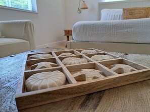 A wooden tray with carved designs on a wooden table in a hotel room. - Costa Azul Bimini Bay (Bailey Town)