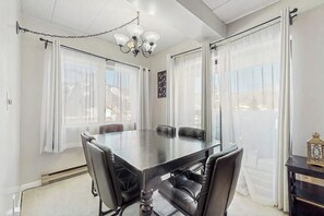 Un salón de conferencias con una mesa, sillas y una araña.