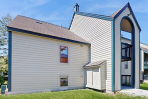 A two-story house with a gabled roof and a small porch. - Ski-In/Ski-Out Condo w/ Pool & Seasonal Hot Tubs - Golf & Tennis Nearby (Ludlow)