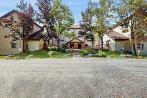 A residential building with a central entrance, multiple windows, and a gravel driveway. - Studio w/ mountain view, shared pool, hot tub, sauna, tennis courts & shuttle (Dover)