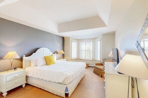 A bedroom with a bed, nightstands, a desk, and a chair. - Ski-in/out condo with pool, 2 hot tubs, sauna - short walk to Solitude clubhouse (Ludlow)