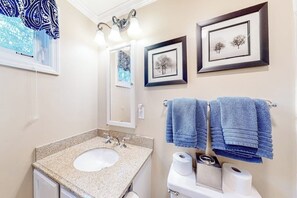 A bathroom with a sink, mirror, towel rack, framed pictures, and a window with a patterned curtain. - Mountain-view condo with skiing nearby, pool, and balcony - snowbird-friendly (Ludlow)