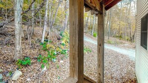 A wooden structure with a view of a forested area.