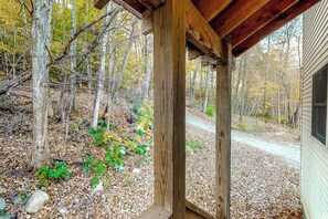A wooden structure with a view of a forested area. - Two-story, dog-friendly house (Wardsboro)