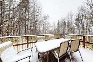 A snow-covered deck with a table and chairs, surrounded by trees. - Dog-friendly home w/ WiFi, private washer/dryer, and electric fireplaces (West Dover)