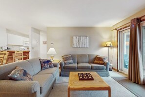 A living room with two sofas, a coffee table, a lamp, and a painting on the wall. - Ski-in/ski-out condo w/ deck, wood-burning fireplace, wifi, community amenities (West Dover)