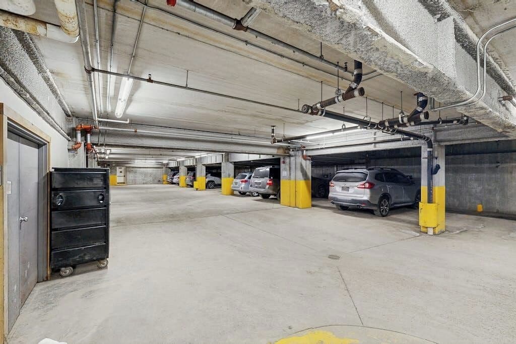 A multi-level parking garage with concrete floors and yellow pillars.