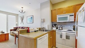 A compact kitchen with a microwave, stove, and refrigerator. - Walk to lifts, condo at Stratton Mountain, fireplace, pool, hot tubs, sauna (Stratton)