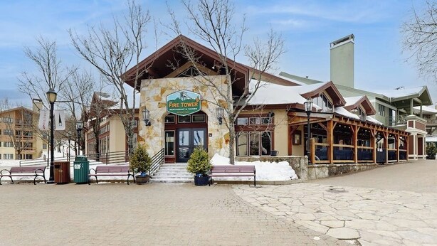 A building with a sign reading 'Fire Tower Restaurant & Tavern.' - Walk to lifts, condo at Stratton Mountain, fireplace, pool, hot tubs, sauna (Stratton)