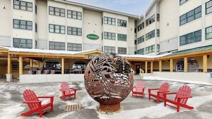 A building with a sign reading 'Landmark' and a large spherical sculpture in the center. - Walk to lifts, condo at Stratton Mountain, fireplace, pool, hot tubs, sauna (Stratton)