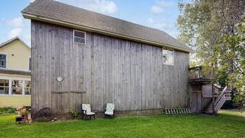 A wooden barn with a gabled roof, a small window, and a number '2356' on the side.