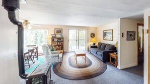 A living room with a fireplace, a sofa, a coffee table, and a bookshelf.