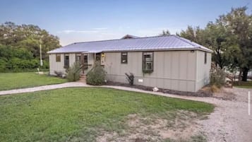 A single-story building with a metal roof, a front entrance, and a small porch.
