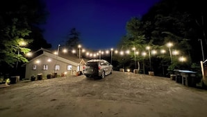 A gravel driveway leading to a building with a car parked in front. - Riverfront house w/ valley & distant mountain views, fireplace, w/d, wifi (Stowe)