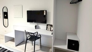 A modern bedroom with a white desk, a black chair, a television, and a wardrobe. - CloudBA Fitz Roy Apartments (Buenos Aires)