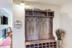 Ein hölzerner Garderobenhaken mit Haken, Ablagefläche und einem Unterteil mit Regalen.