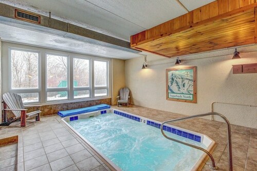 Ski-in/out condo with pool, hot tub, game room, mountain view, & fireplace