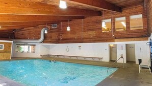 An indoor swimming pool with wooden walls and ceiling, a visible window, and a pool ladder. - Convenient Skier-friendly 1BR condo, pool, gym, tennis, fireplace, wifi (Warren)
