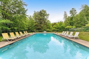A rectangular pool with clear blue water, surrounded by a metal fence. - Convenient townhouse w/ seasonal mountain views, pool, tennis, w/d, a/c, wifi (Warren)
