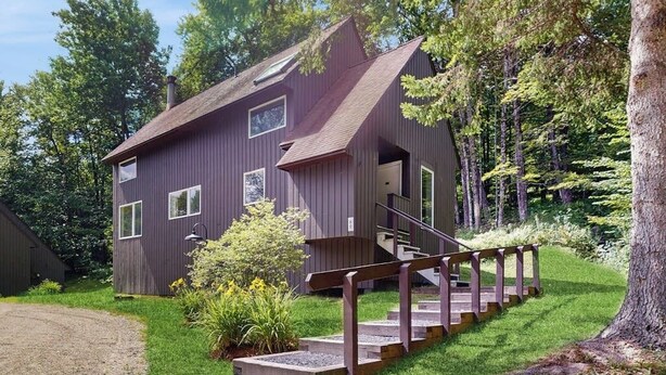 A modern two-story house with a wooden staircase leading to the entrance. - Home w/ mountain view, deck, shared pool & tennis, w/d (Warren)