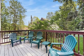 A wooden deck with green Adirondack chairs and a small table. - Home w/ mountain view, deck, shared pool & tennis, w/d (Warren)