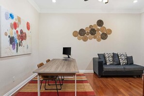A modern living room with a dining table, sofa, and abstract art on the walls. - Rancho Agave Azul Family Retreat Near Wine Country (Murrieta)
