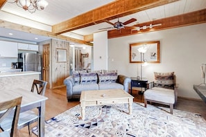A living room with a sofa, coffee table, and patterned rug. - Ski-in/Ski-Out, Outdoor Pool, Hot Tub, Tennis, Sauna, & Gym (Steamboat Springs)