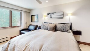 A bedroom with a bed, a chair, a ceiling fan, a window, and wall-mounted lights. - 1 Block to Vail Mountain! Village Condo w/ Fireplace, Great Views & Shared Pool (Vail)