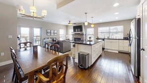 A spacious kitchen with a dining area, a central island, and a large island with a sink. - Family-friendly condo w/mountain & valley views, WiFi, shared pool, hot tub (Granby)