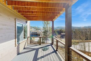 A wooden deck with a view of a mountain landscape. - Modern townhome w/ mountain views, 2 outdoor spaces, & a gas grill (Fraser)