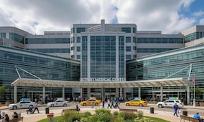 A modern building with a large glass facade, labeled 'Detroit Medical Center.' - Lux Mins to /Wayne State/ & /DMC/ Ford Field/ MGM (Detroit)