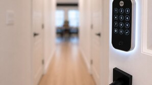 A modern hallway with a Yale smart lock on a white door.