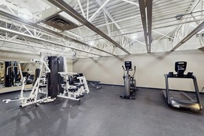 A gym with exercise equipment, a treadmill, and a mirror. - Studio on the Shuttle Route with WiFi and Shared Pool, Hot Tubs, and Gym (Winter Park)